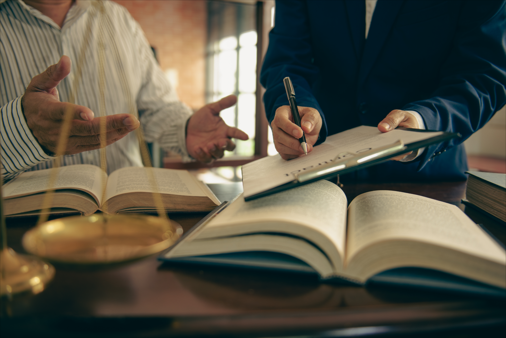 Lawyers discussing documents at a desk
